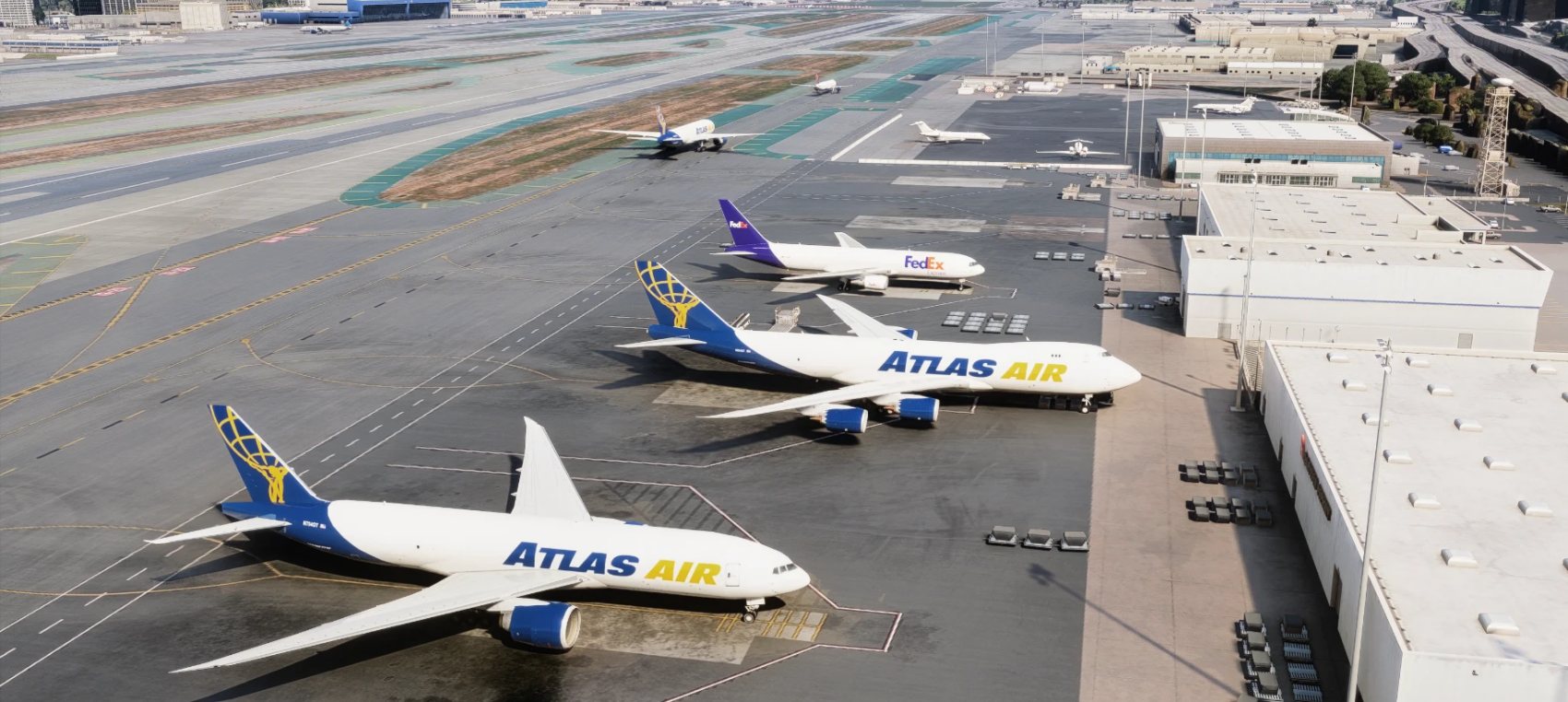 Atlas Air 747-8F and 777F and a FedEx 767F on the cargo ramp of Los Angeles.