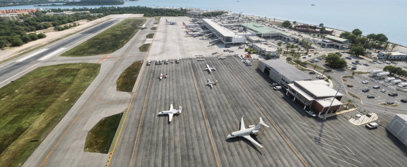 Business jets and light aircraft on the general aviation apron of Key West, American Airlines at the gates.